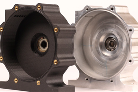 Two circular machine parts, one black, one silver, with bolt holes and central bearings.