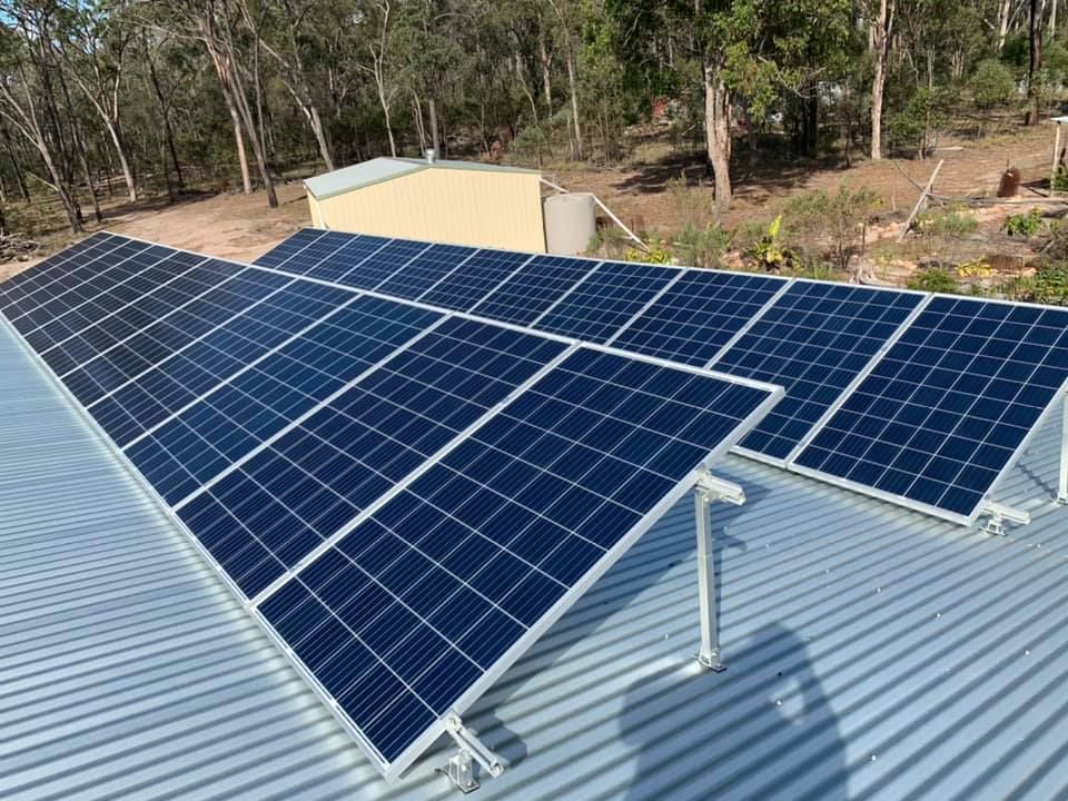 A Row of Solar Panels Are Sitting on Top of A Metal Roof — Evolution Solar Kingaroy in Kingaroy, QLD