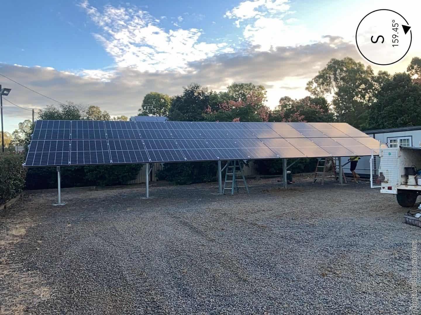 A Lot of Solar Panels Are Sitting in A Gravel Lot — Evolution Solar Kingaroy in Kingaroy, QLD