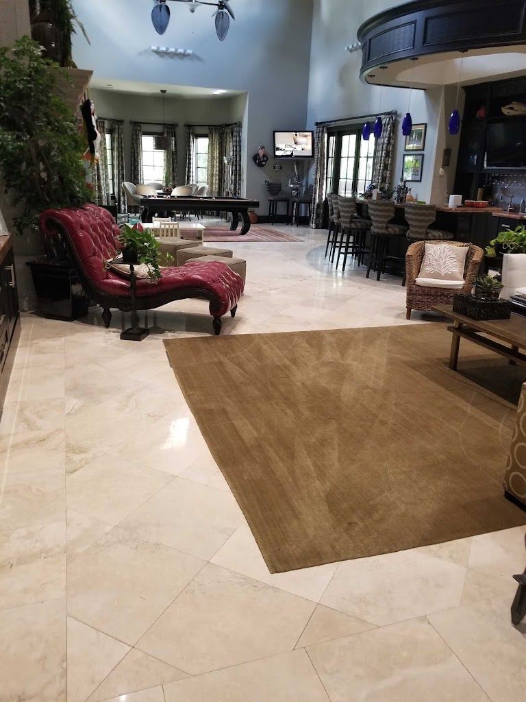 A living room with a pool table , chairs , and a rug.