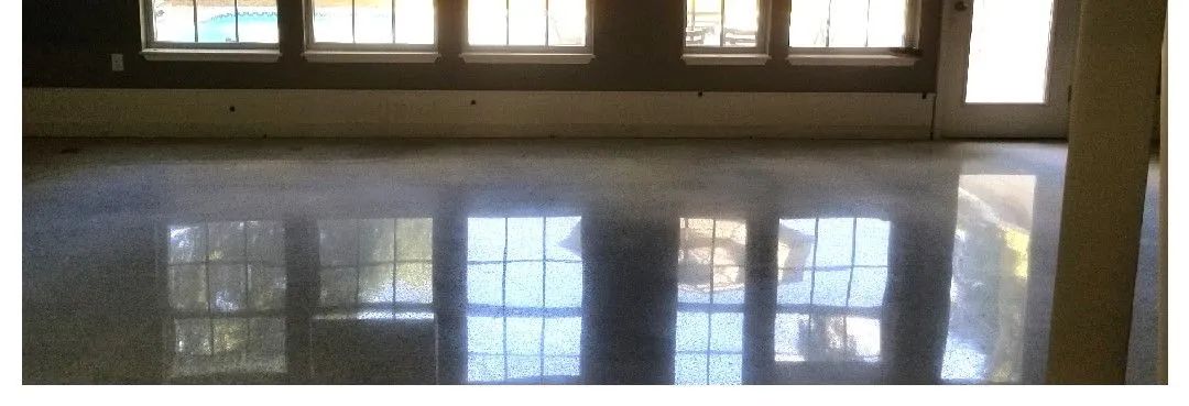 A room with a lot of windows and a shiny floor