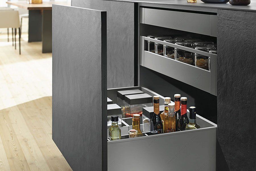 Modern kitchen cabinet with a pull-out organizer holding spices and bottles