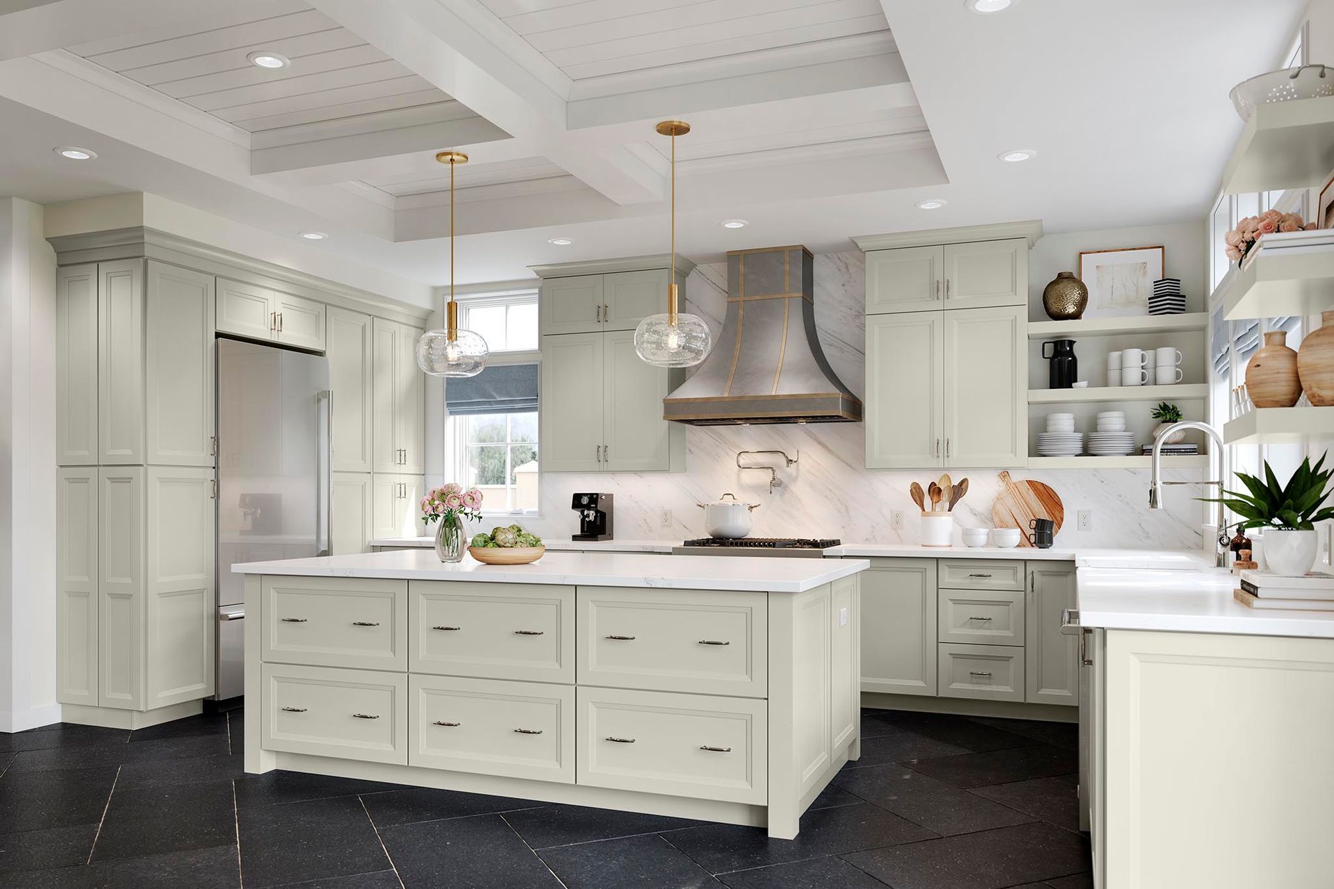 Bright white modern kitchen with large island, stainless range hood, and built-in cabinets