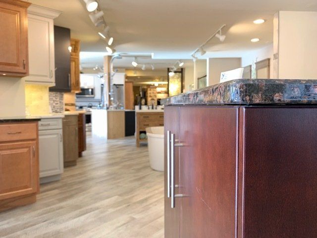 Modern kitchen with wood cabinets, granite island, and light wood flooring
