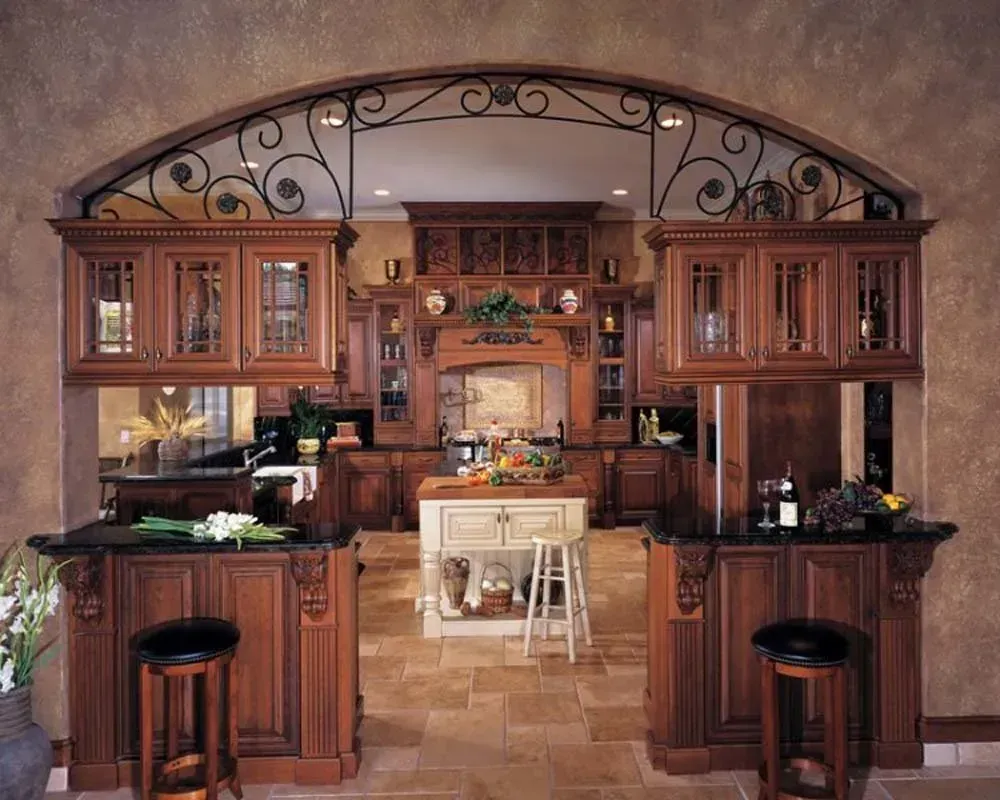 Warm wooden kitchen with arched iron detail, central island, and built-in cabinets.