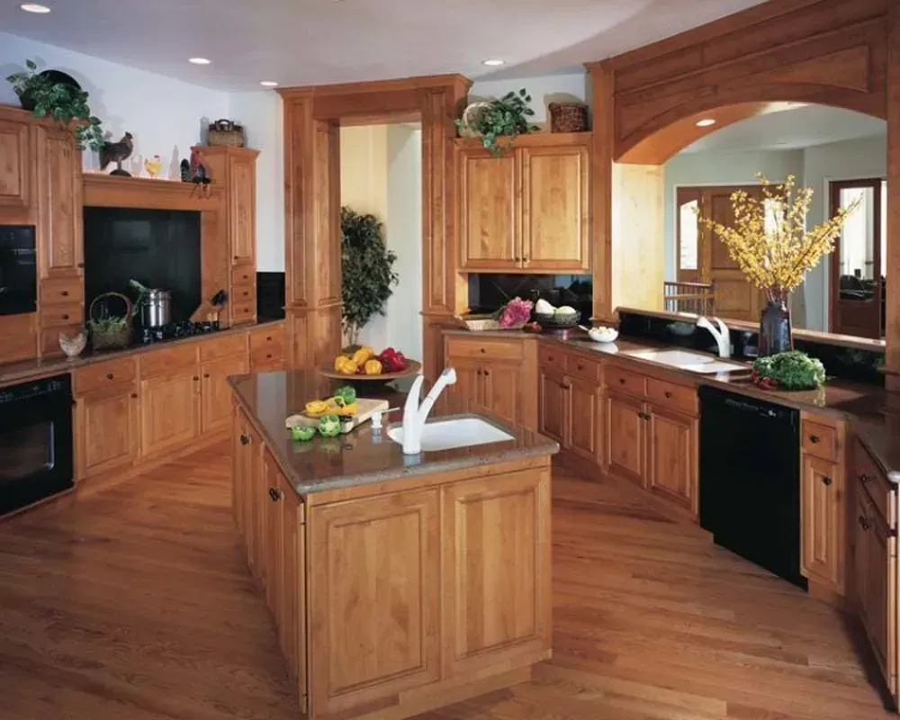 Spacious wooden kitchen with central island, stainless sink, and large arched windows