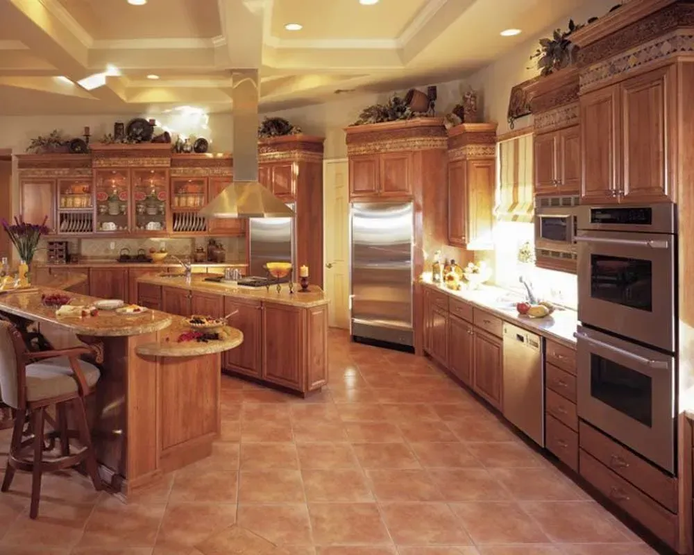 Spacious gourmet kitchen with warm wood cabinetry, stainless steel appliances, and a tiled floor