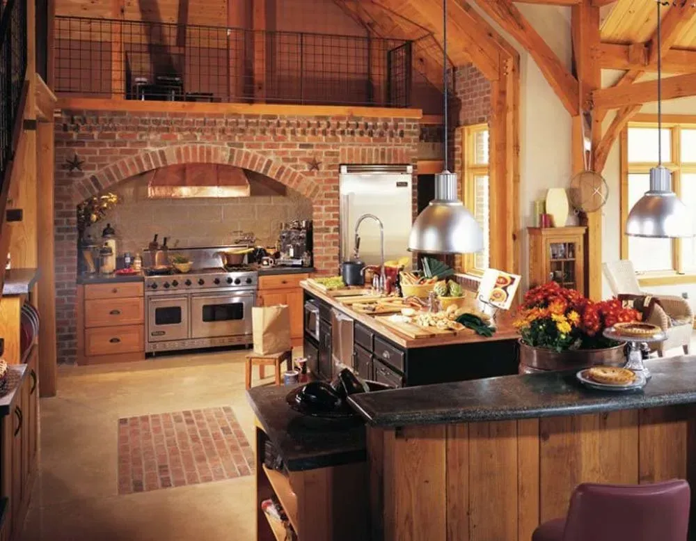 Cozy rustic kitchen with brick arch, wood island, stainless stove, and hanging pendant lights