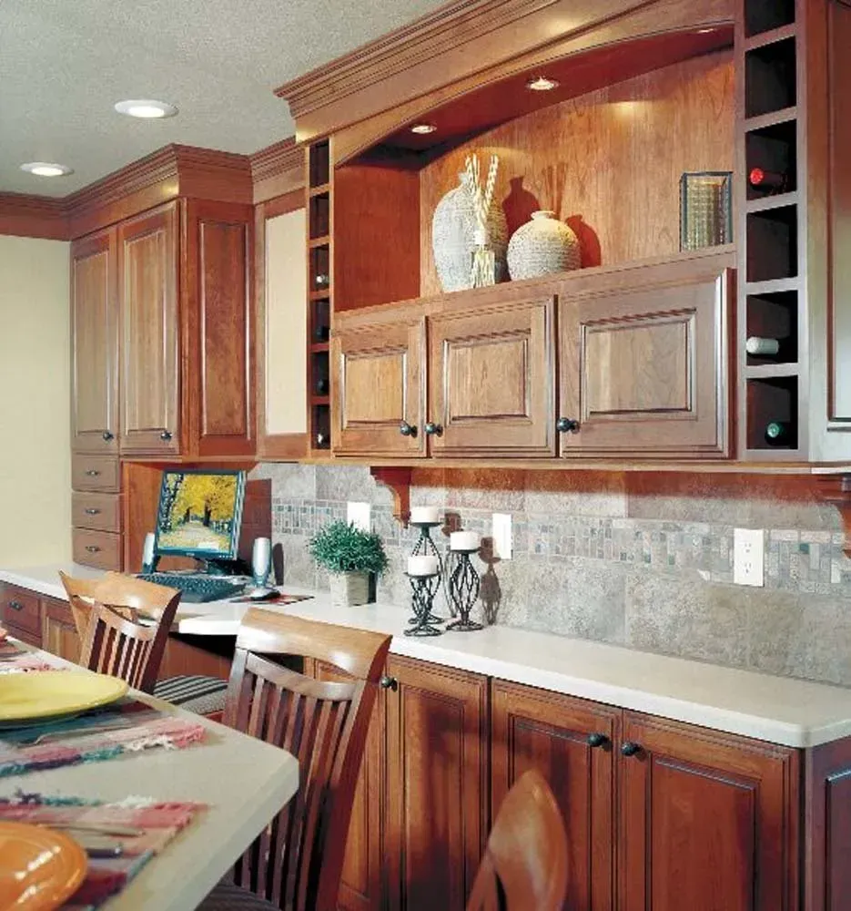 Modern kitchen with wooden cabinets, island seating, countertop decor, and warm wood finishes