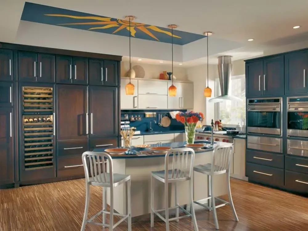 Modern kitchen with dark cabinets, central island, bar stools, and stainless steel appliances