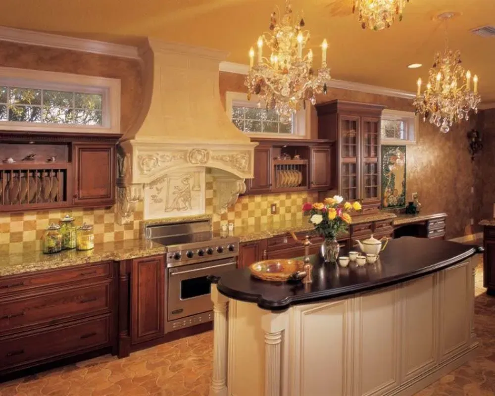 Elegant kitchen with cream cabinetry, dark island, chandeliers, and warm tile backsplash