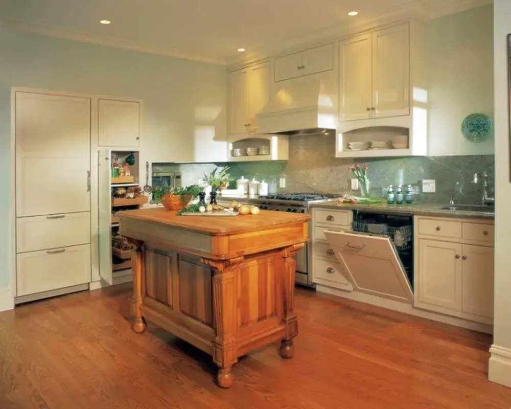 Bright modern kitchen with wood island, white cabinets, and stainless steel appliances