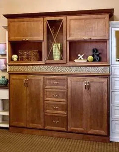 Wooden cabinet with open shelves, center mirror panel, and lower drawers and doors in a living room.