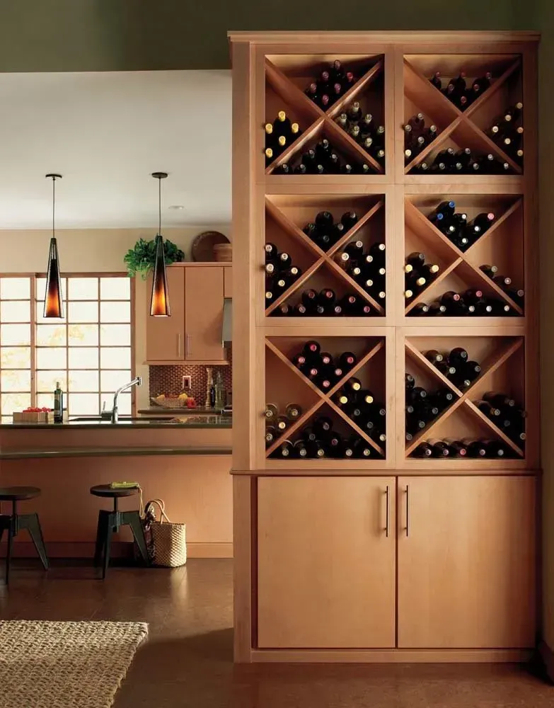 Tall wooden wine cabinet with X-shaped bottle racks in a warm modern kitchen-dining room