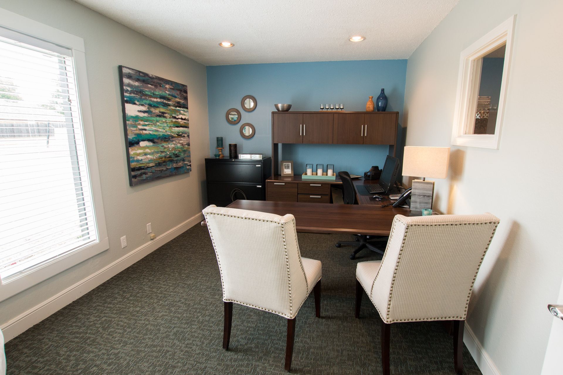 A small office with two chairs and a desk