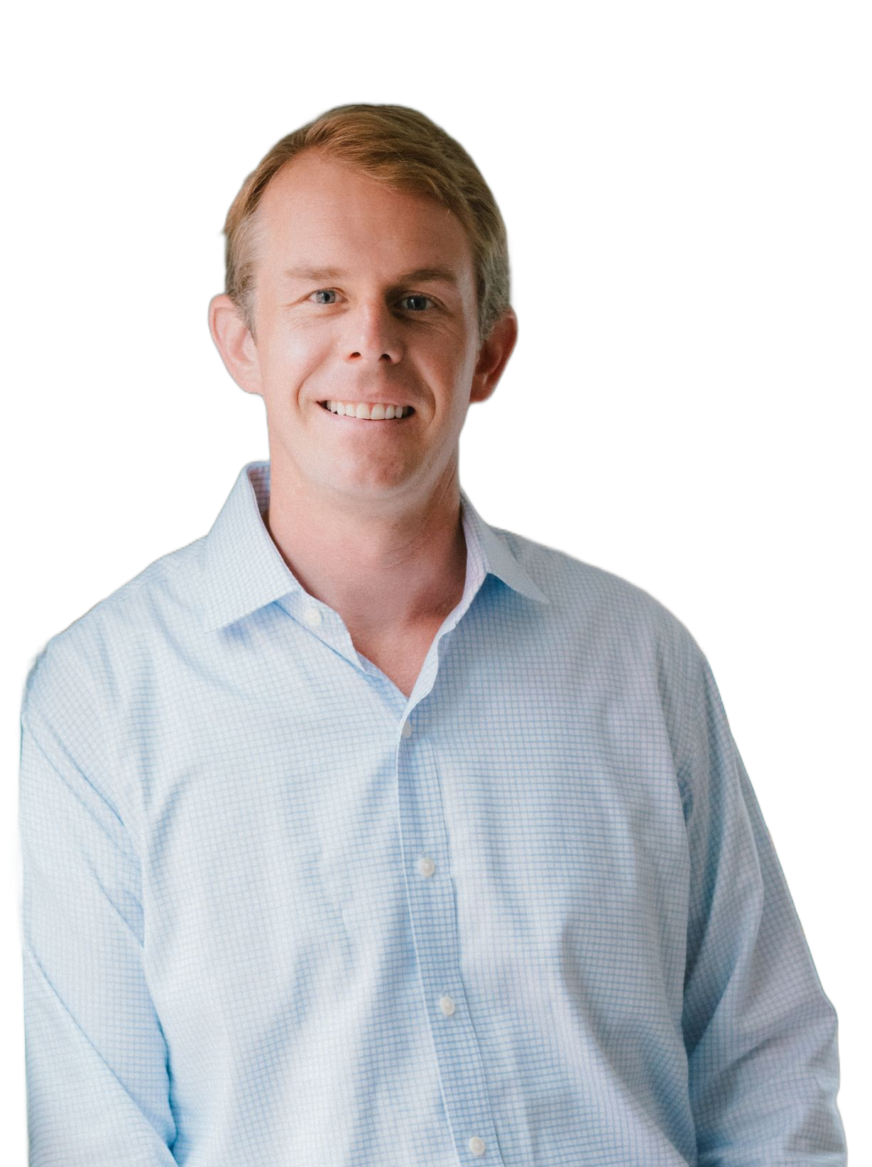 A smiling person wearing a light blue button-down shirt against a plain white background.