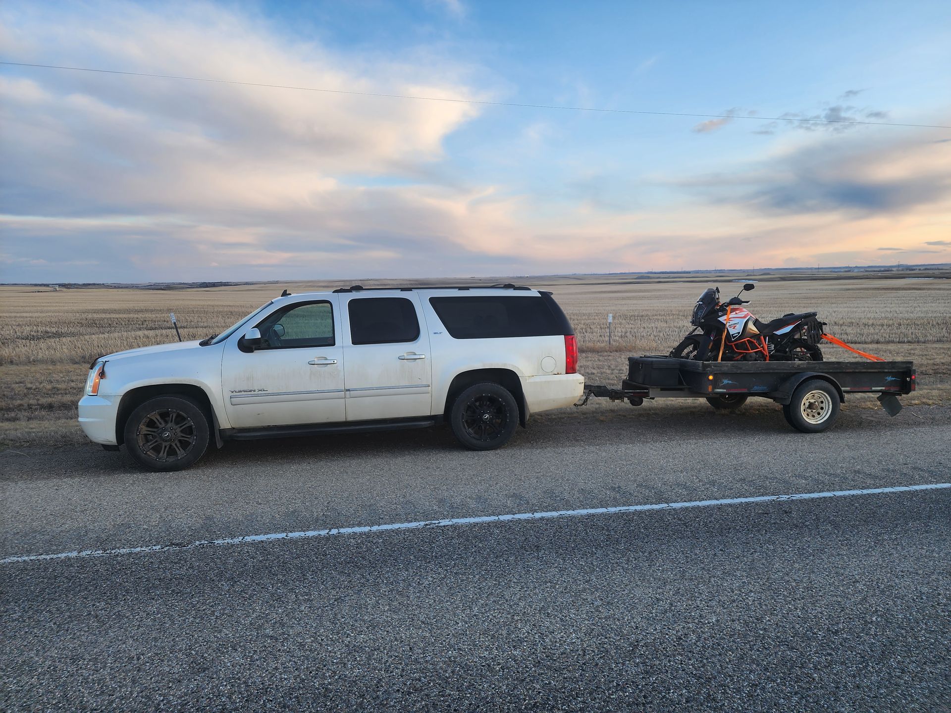 Starland County, AB: Yukon with KTM1290 motorcycle on utility trailer.