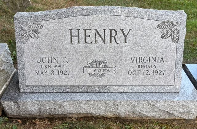 Gray granite headstone for the Henry family, engraved with names, birth dates, and a marriage date of July 2, 1948.