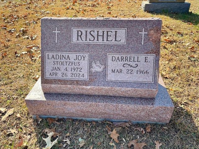 A pink granite headstone engraved with