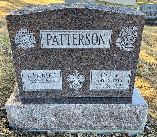 A granite cemetery headstone for the Patterson family, featuring the names E. Richard and Lois M. with dates and emblems.