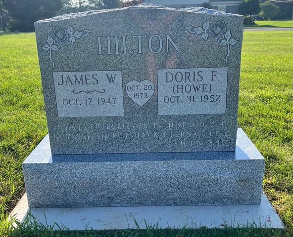A gray granite headstone for James W. and Doris F. Hilton, dated Oct 20, 1973, in a grass field.
