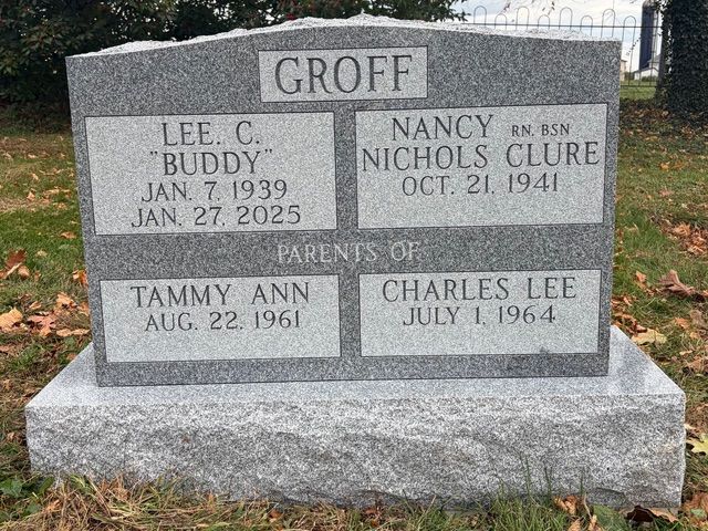 A gray stone headstone inscribed