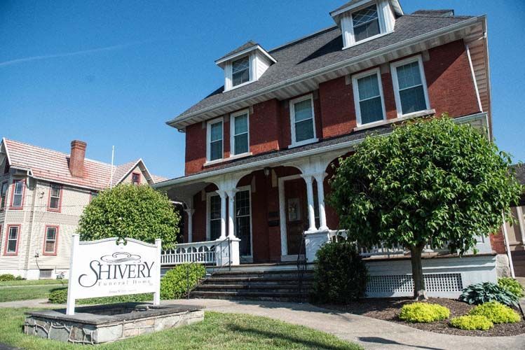Two-story brick building with a sign that reads 