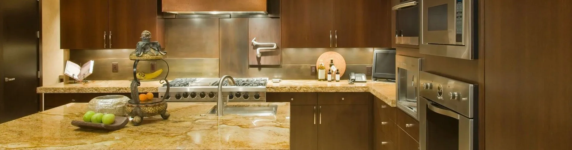A kitchen with stainless steel appliances and wooden cabinets