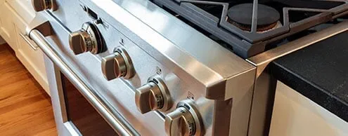 A stainless steel stove top oven is sitting on top of a stove in a kitchen.