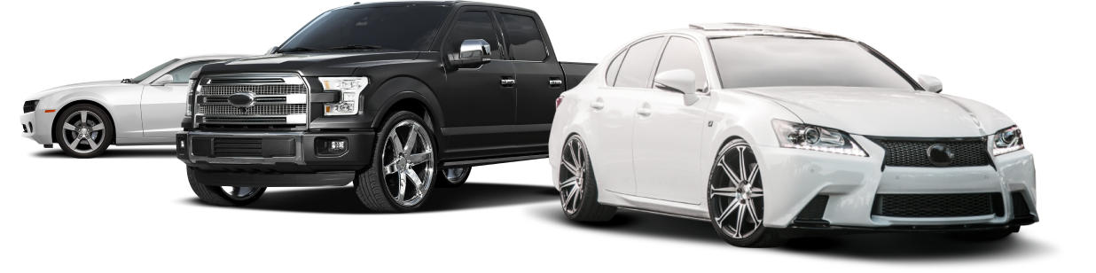 A black truck , a white car , and a white car are parked next to each other | Greatway Tire and Auto Center