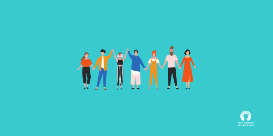Diverse group of people holding hands, on a turquoise background.