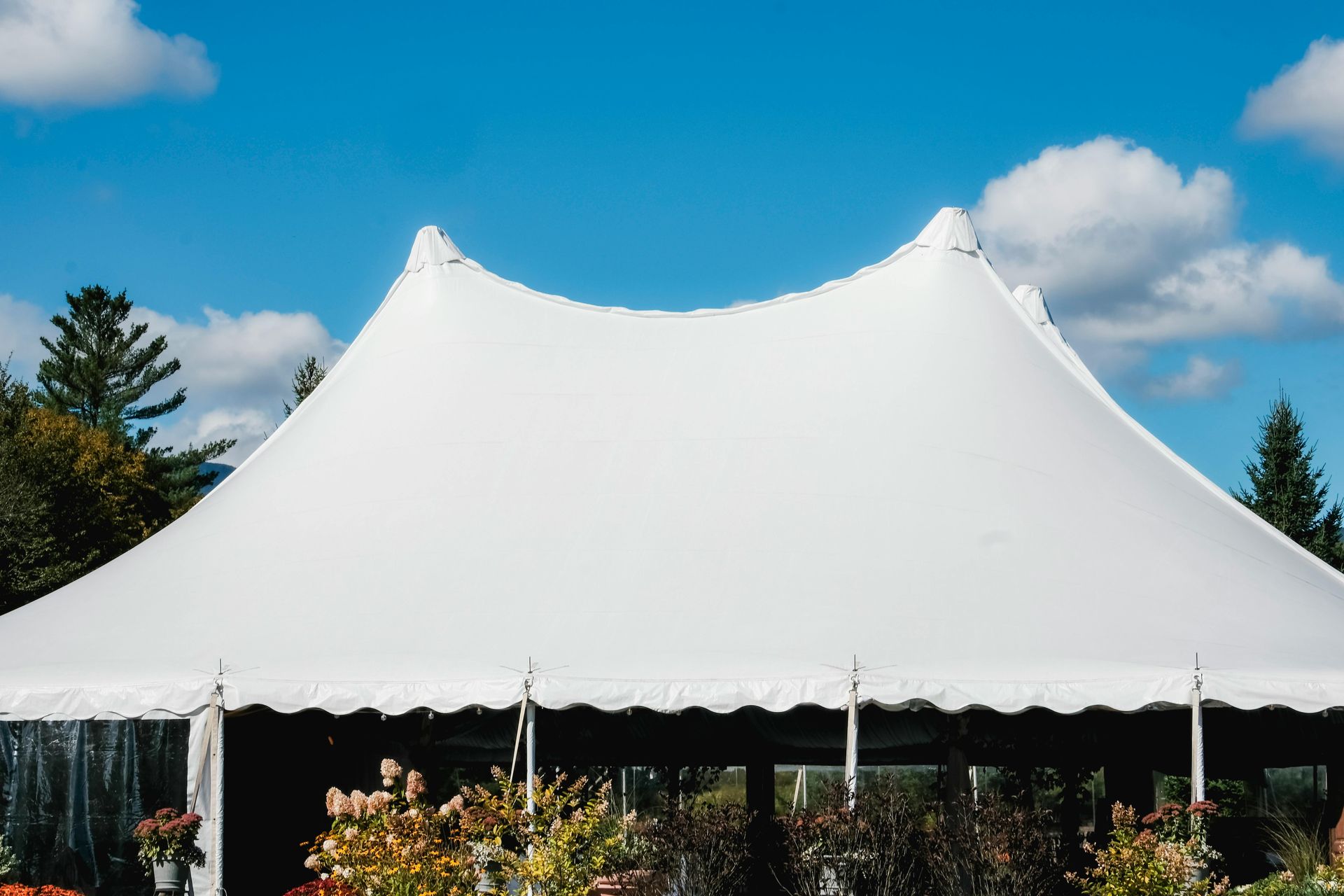 Wedding tent rental with seating arranged for a ceremony