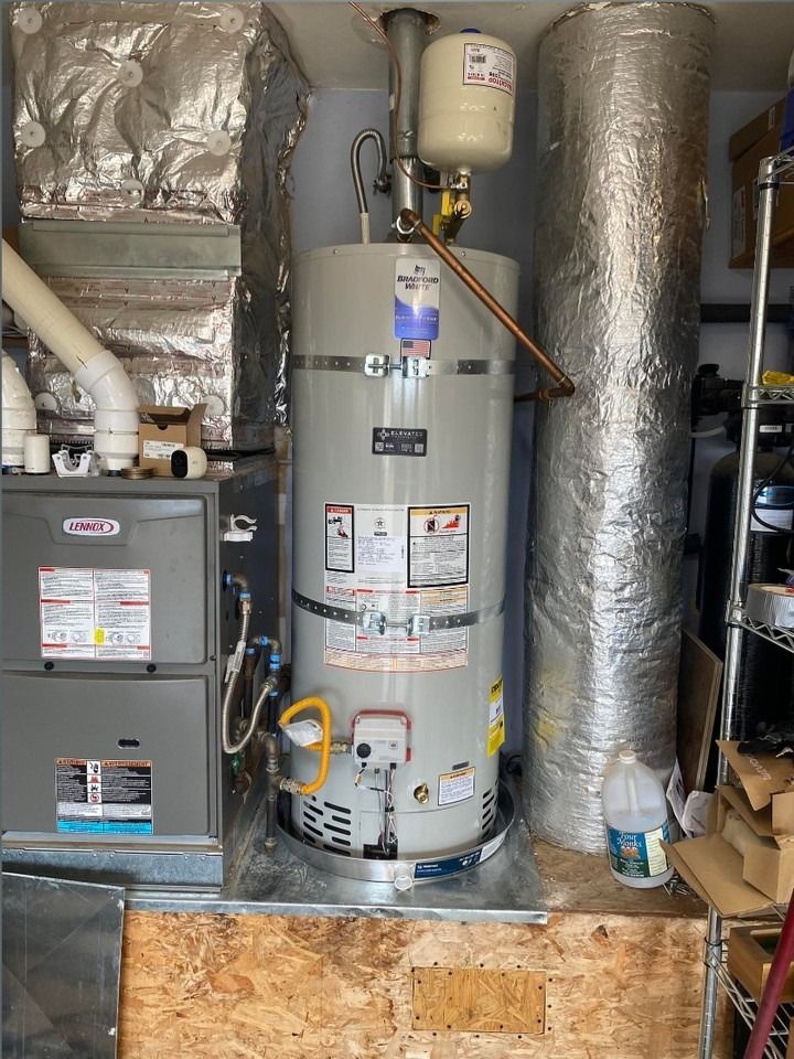 Water heater and HVAC furnace in a utility closet with insulated ducts and pipes.