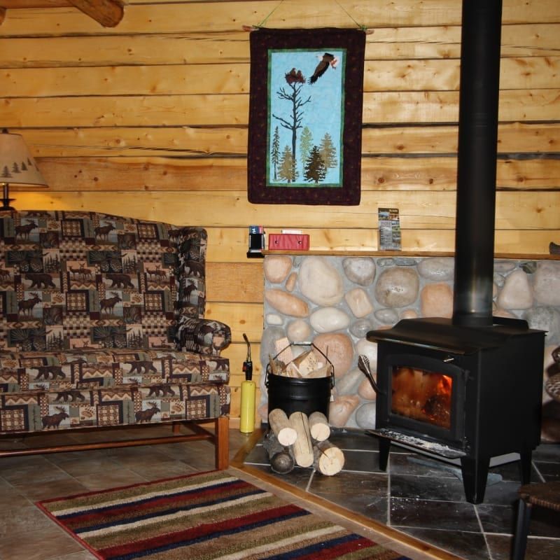 A living room with a couch and a wood stove