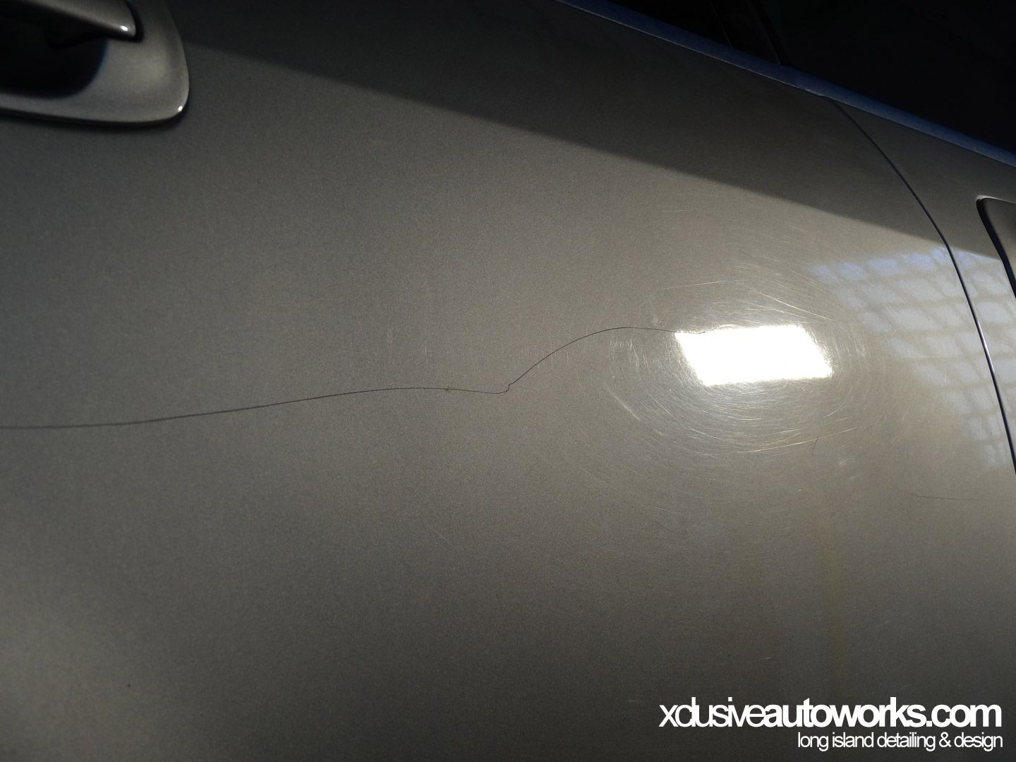 A close up of a car door with xdusveautoworks.com written on the bottom