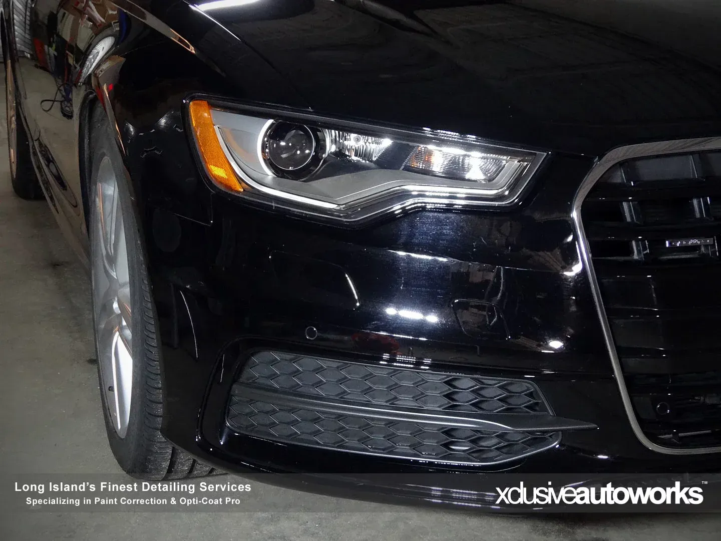A black audi a6 is parked in a garage.