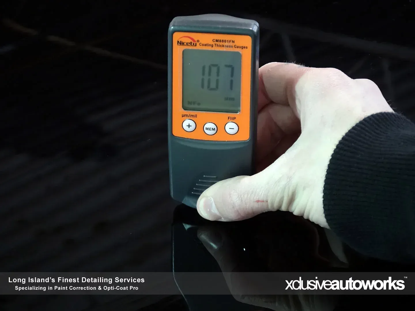 A person is holding a device that says 107 on it