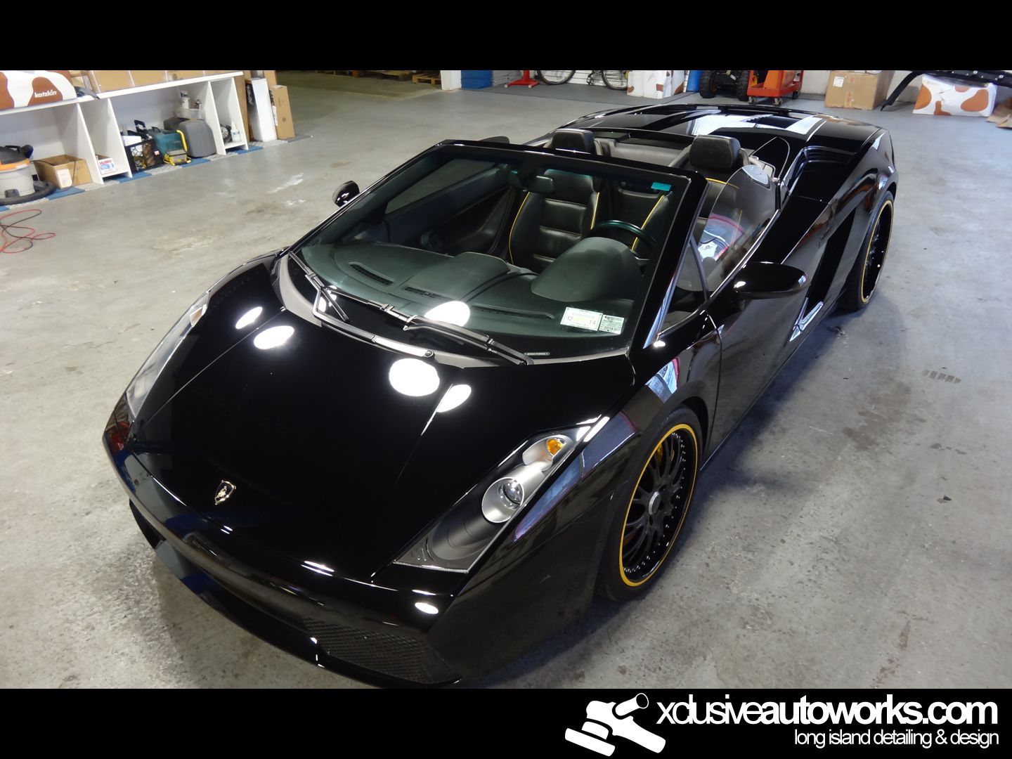 A black sports car with the website xdusveautoworks.com at the bottom