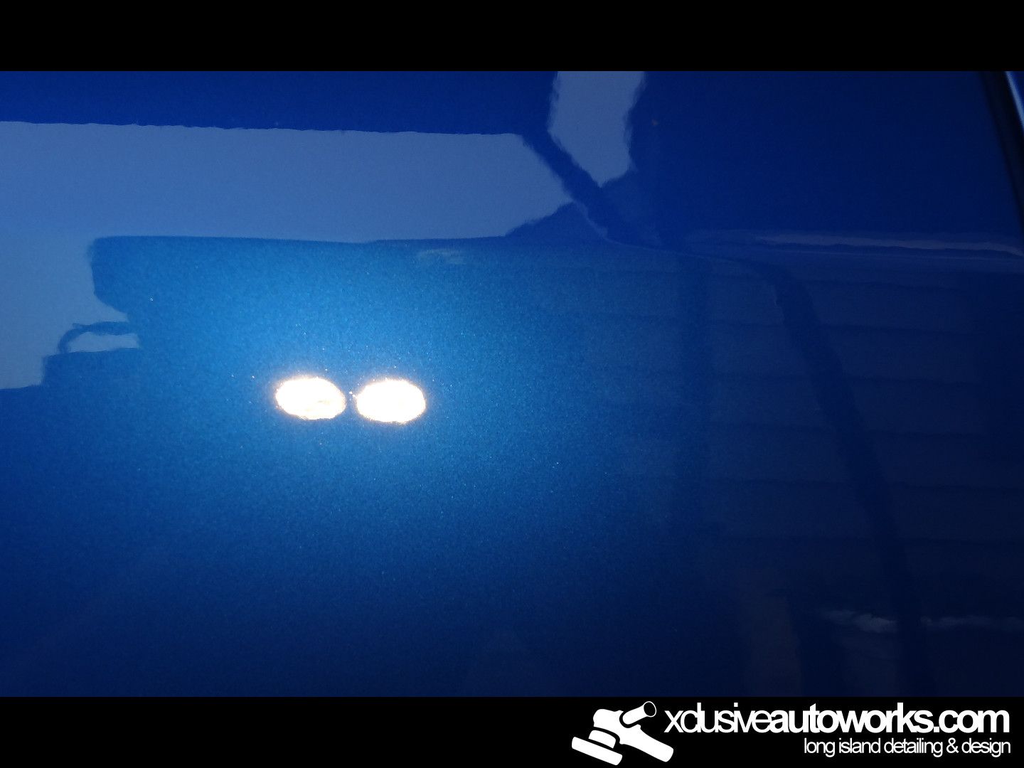 A blue car with the website xdusveautoworks.com on the bottom