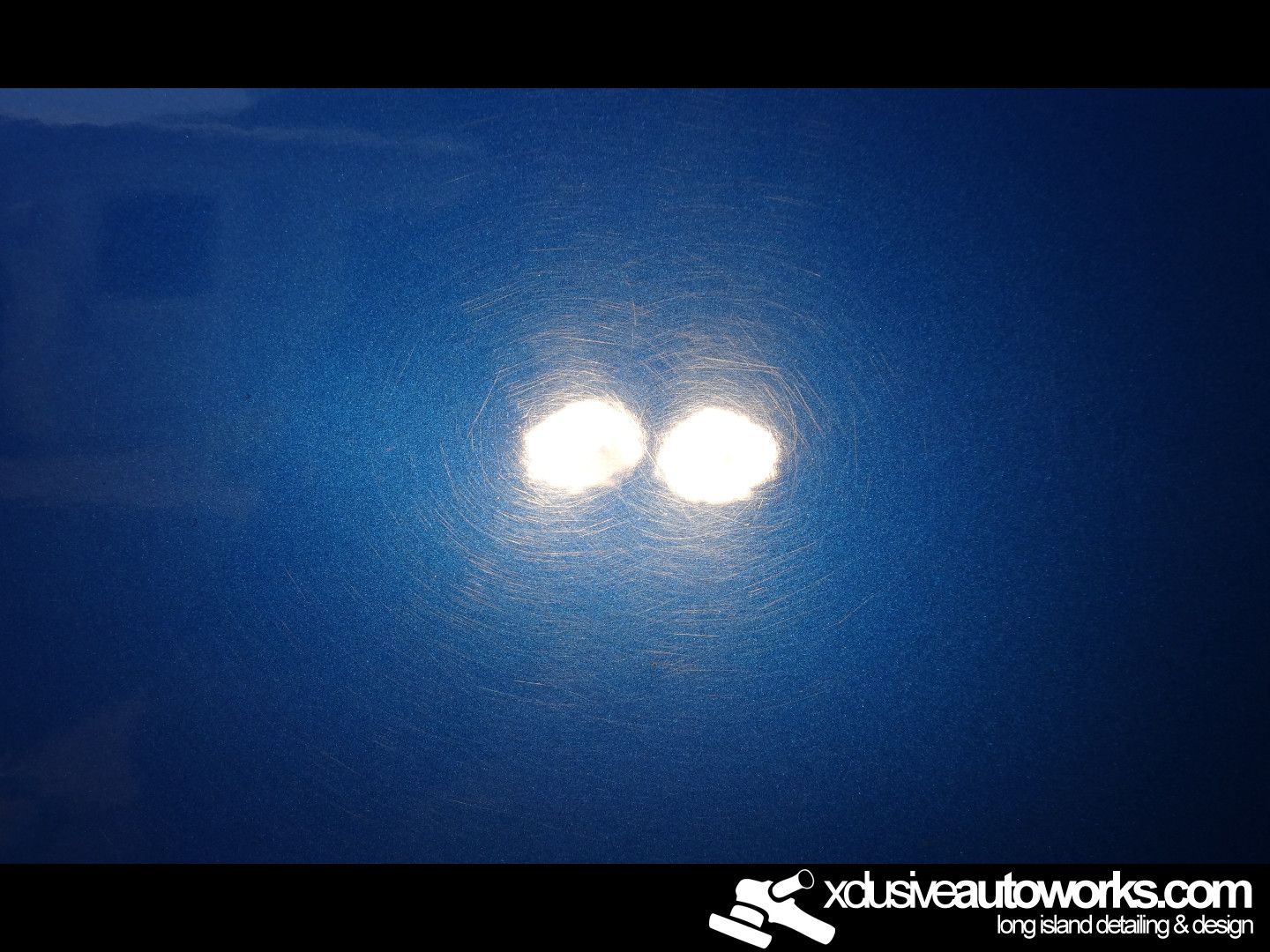 A close up of a blue car with two white spots on it