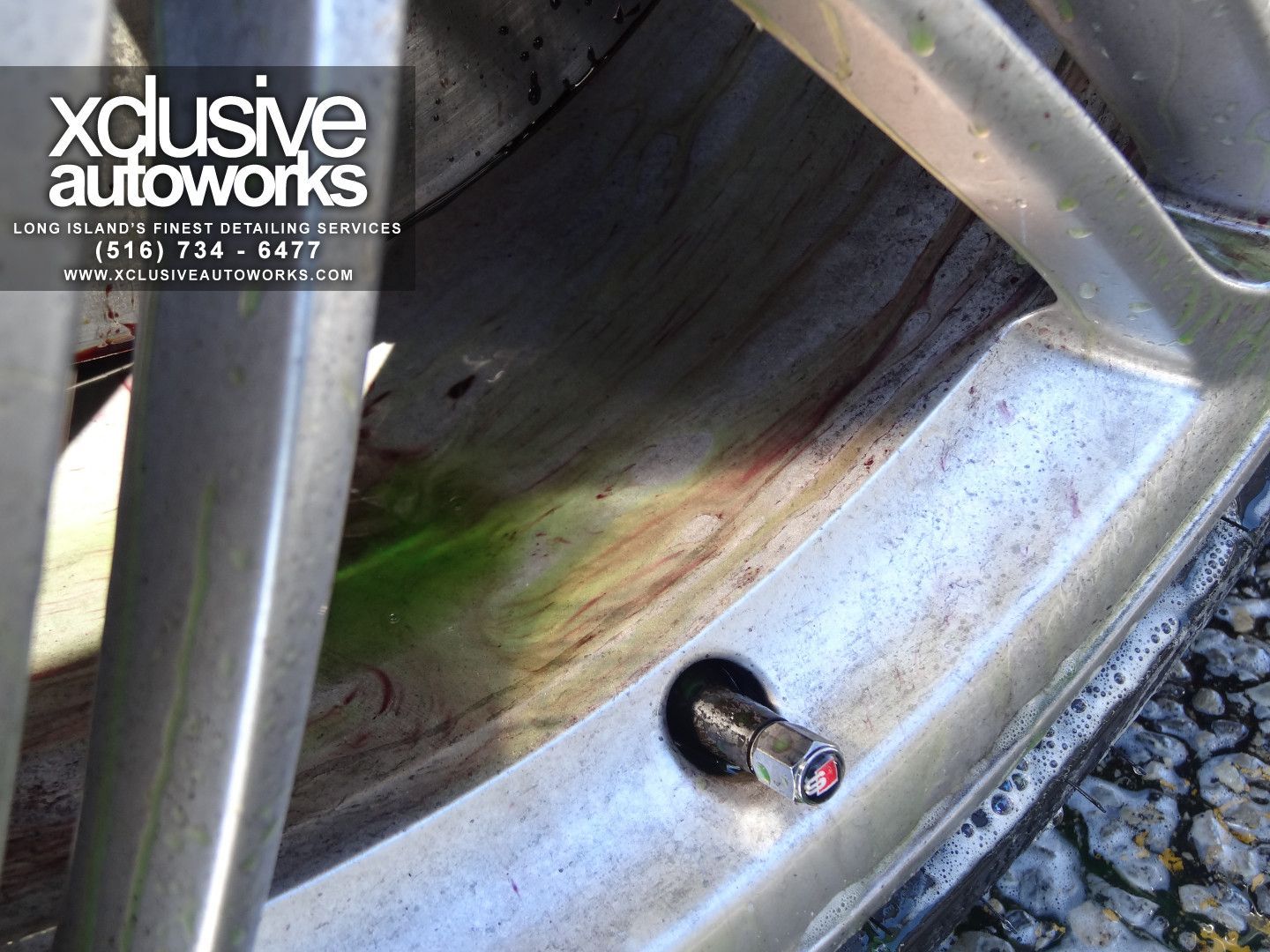 A close up of a tire with xclusive autoworks written on it