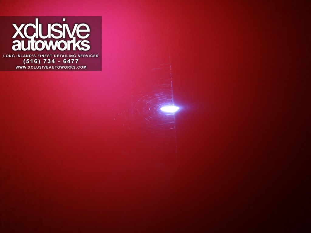 A red background with a logo for xclusive autoworks