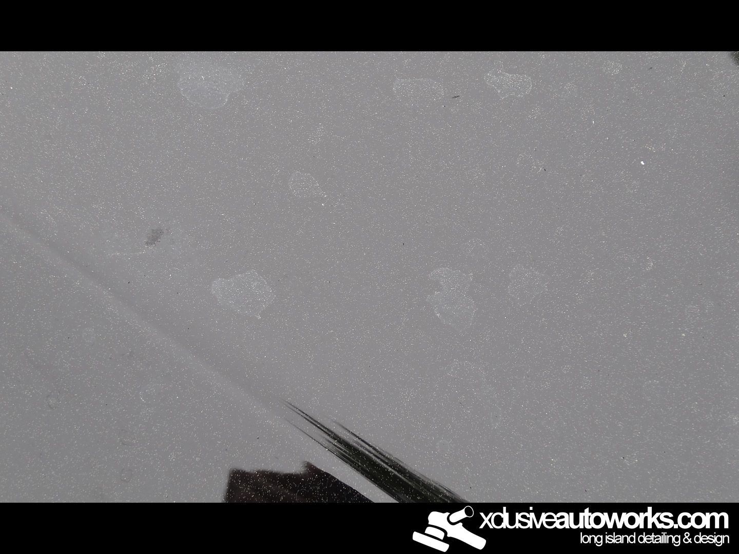 A close up of a car with xclusiveautoworks.com written on the bottom