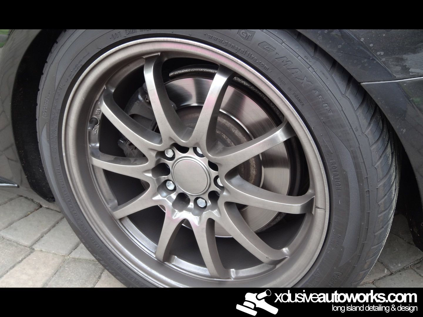 A close up of a car wheel with the website xdusveautoworks.com in the corner