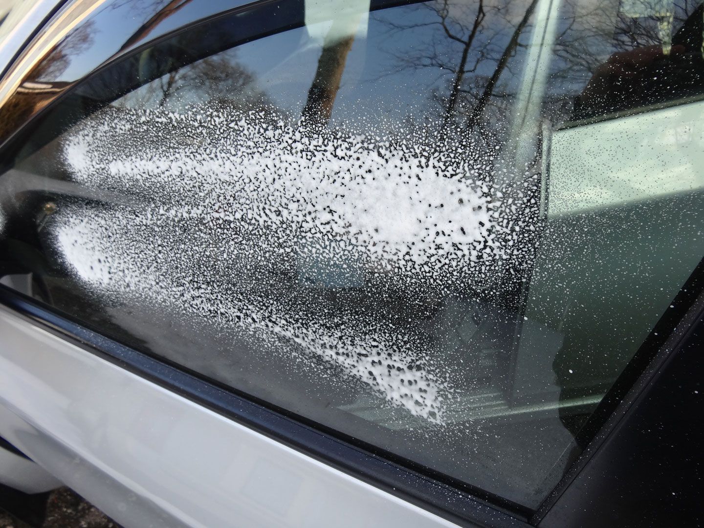 A close up of a car window with a lot of dust on it