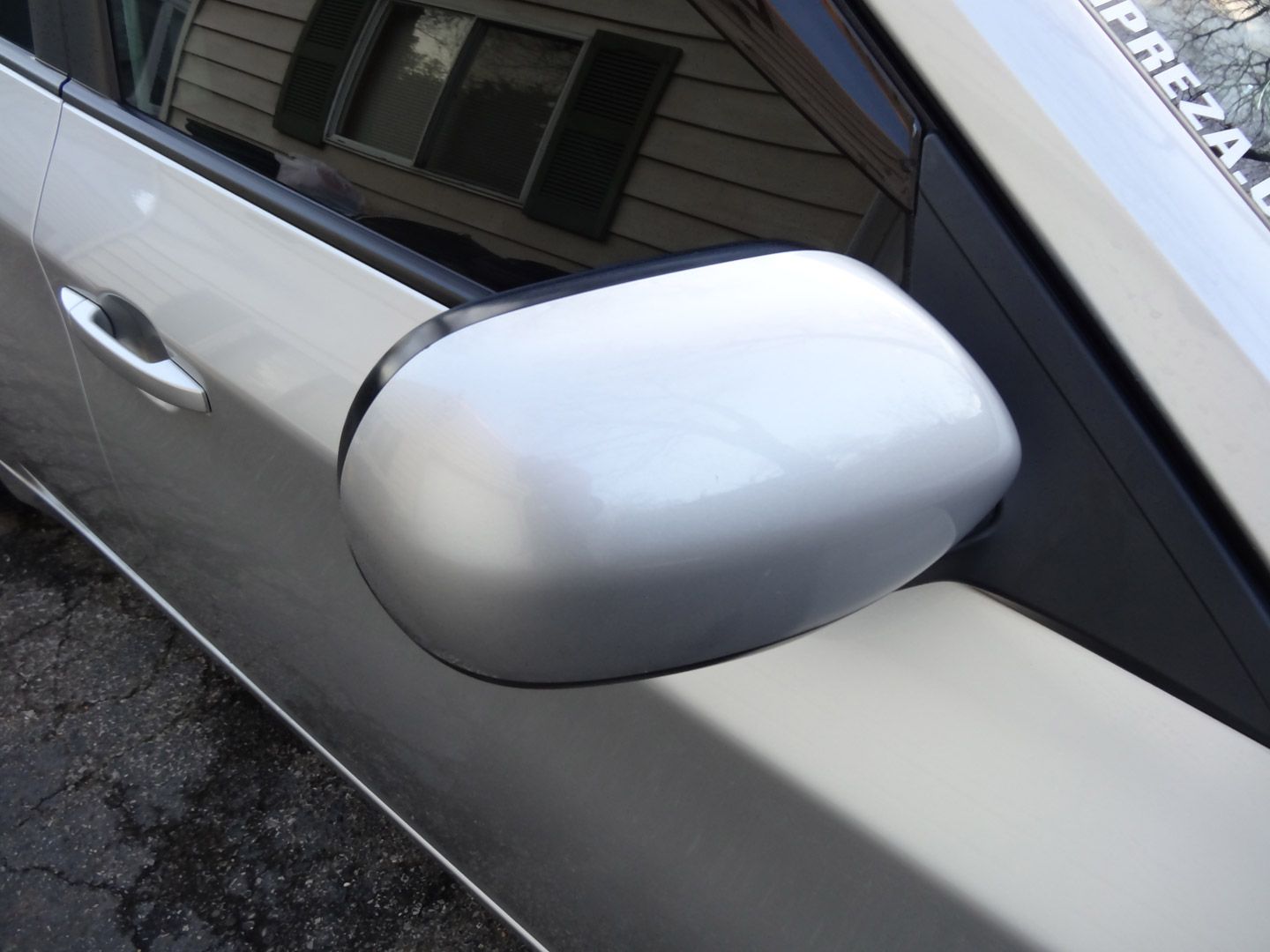 A silver car has a sticker on the windshield that says appreciate