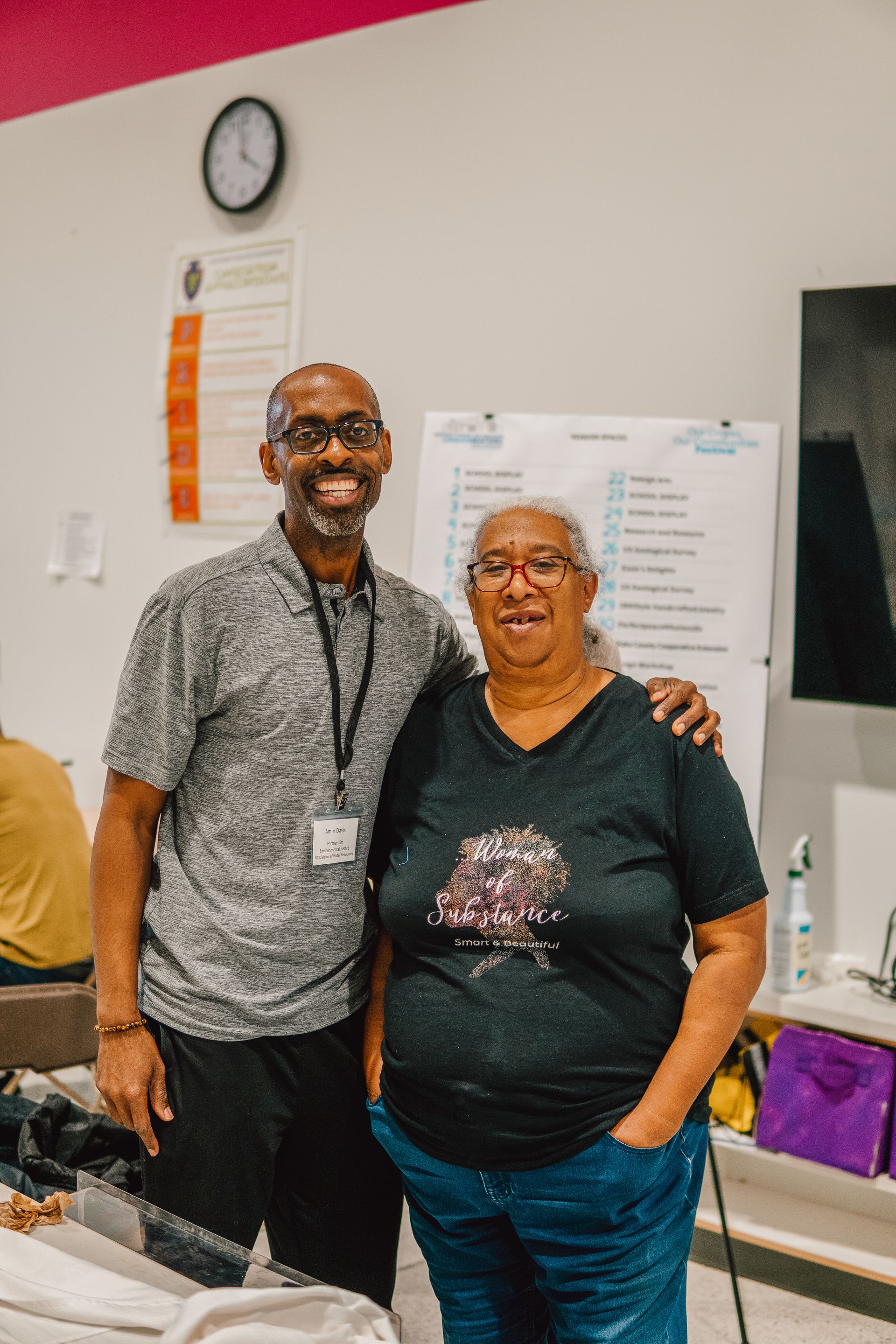 A man and a woman are posing for a picture in a room.