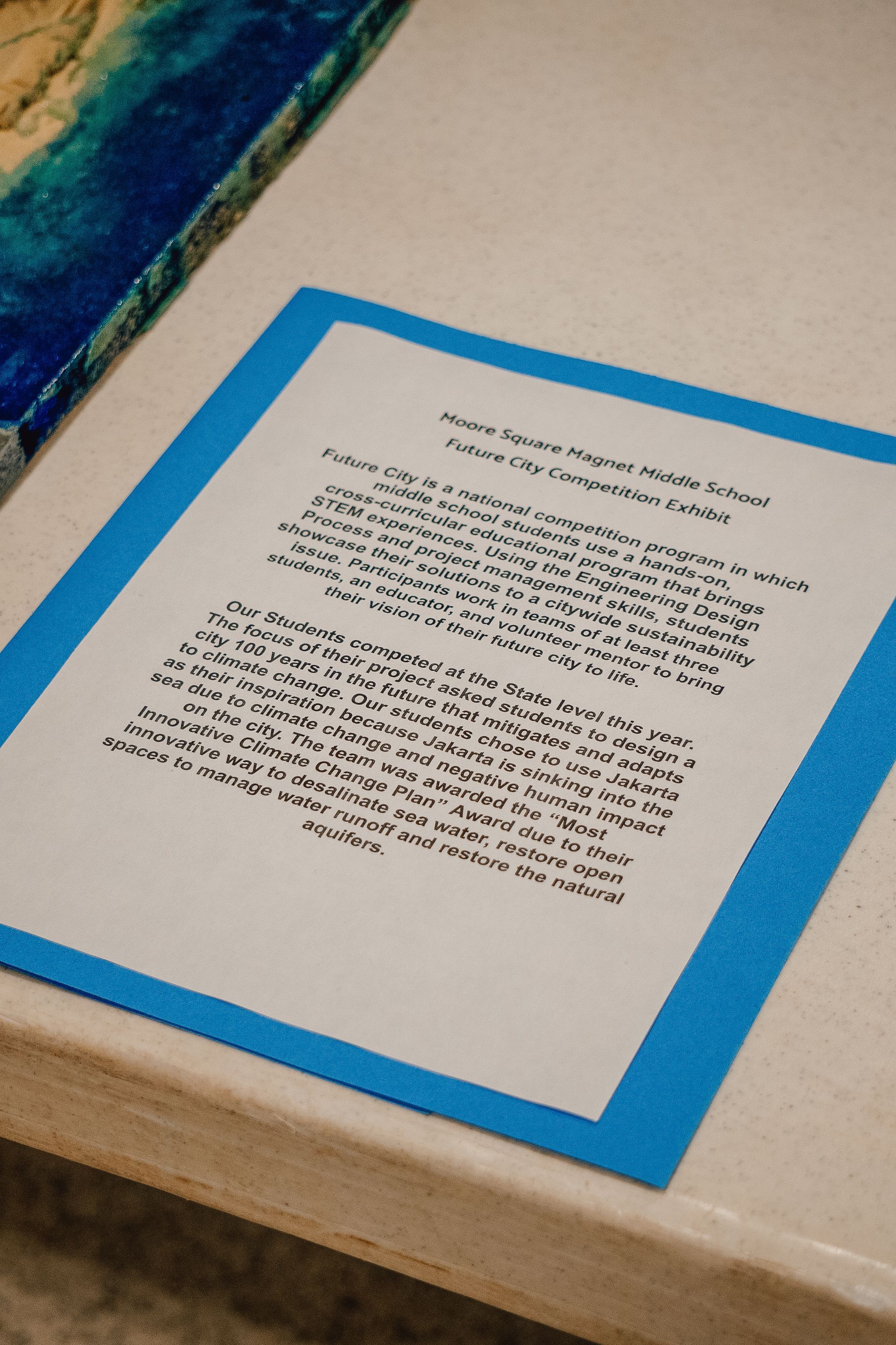 A piece of paper with a blue border is sitting on a table.