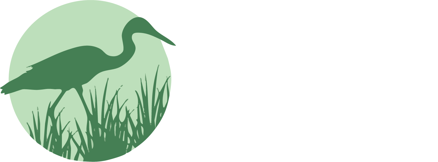 A silhouette of a bird standing in the grass in a circle.
