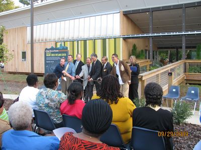 A group of people sitting in front of a building with the date 09/29/2009